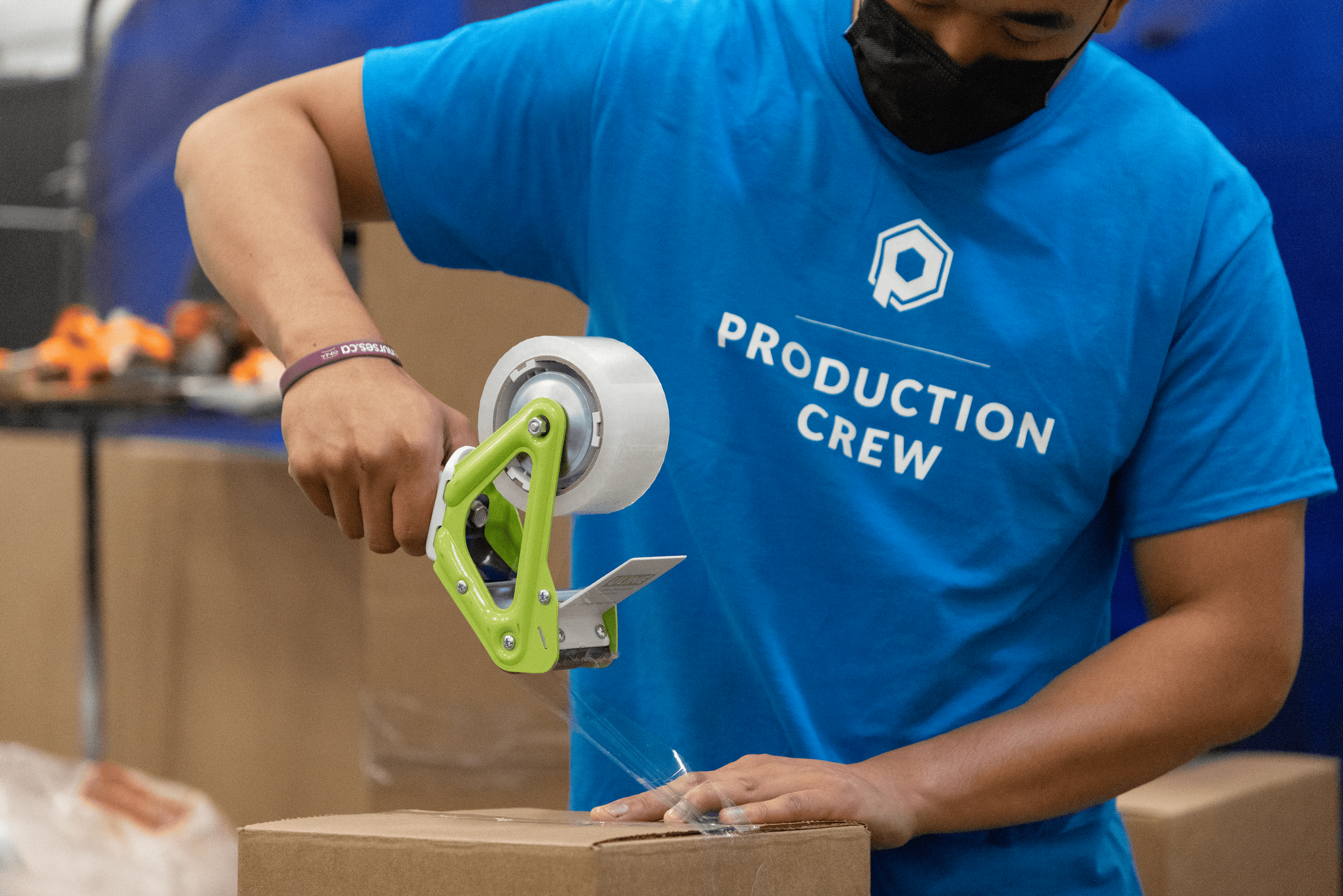 Image of a Proto3000 3D printing technician preparing a box to be shipped