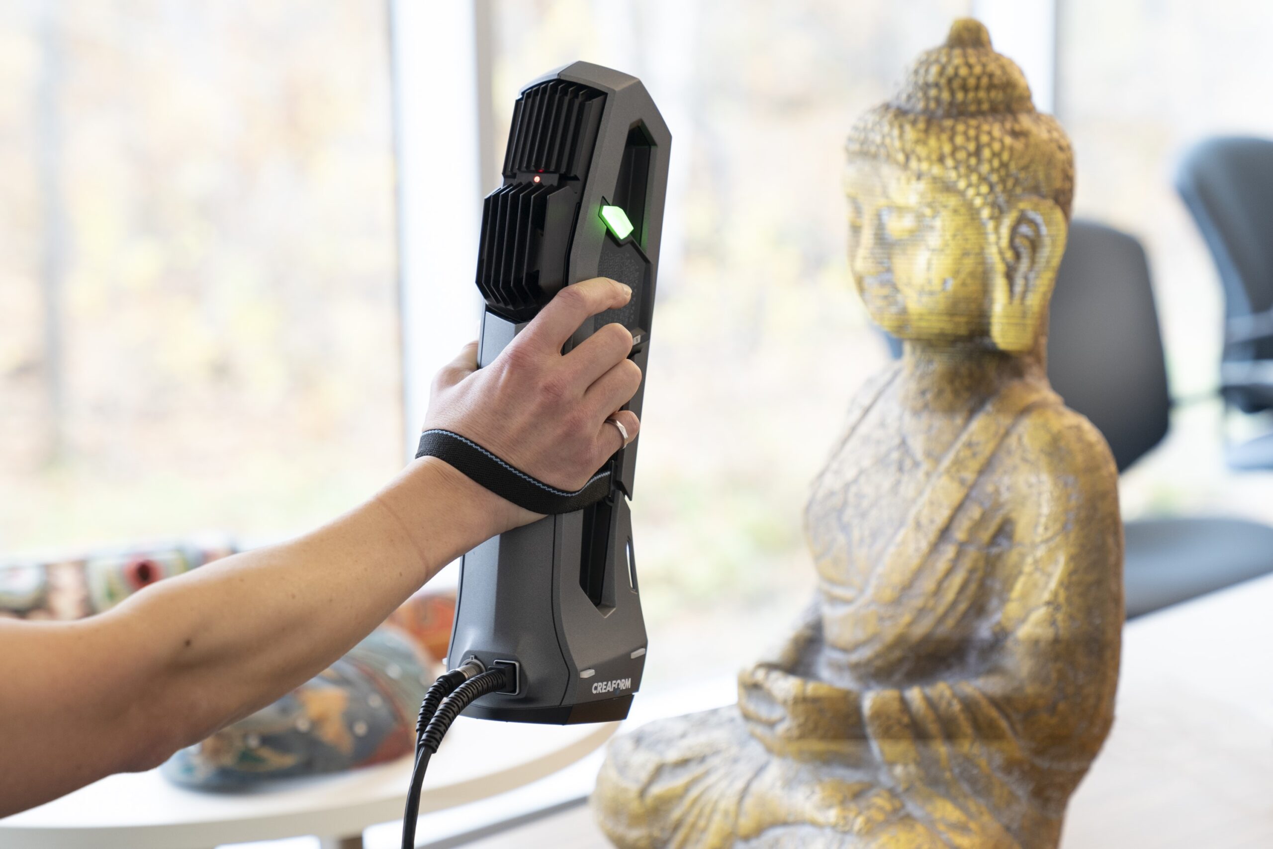 Image shows a Buddha statue being scanned with Creaform Go!SCAN 3D scanner