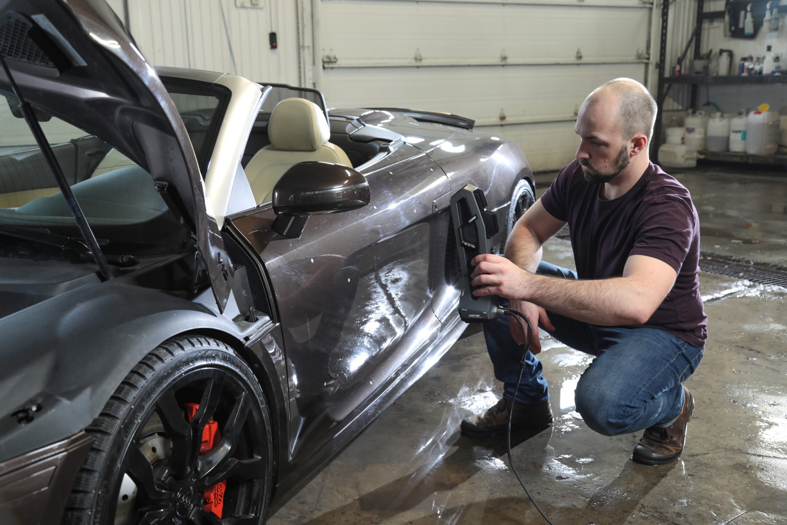 Image shows a man 3D scanning a car with Creafrom Go!Scan 3D scanner