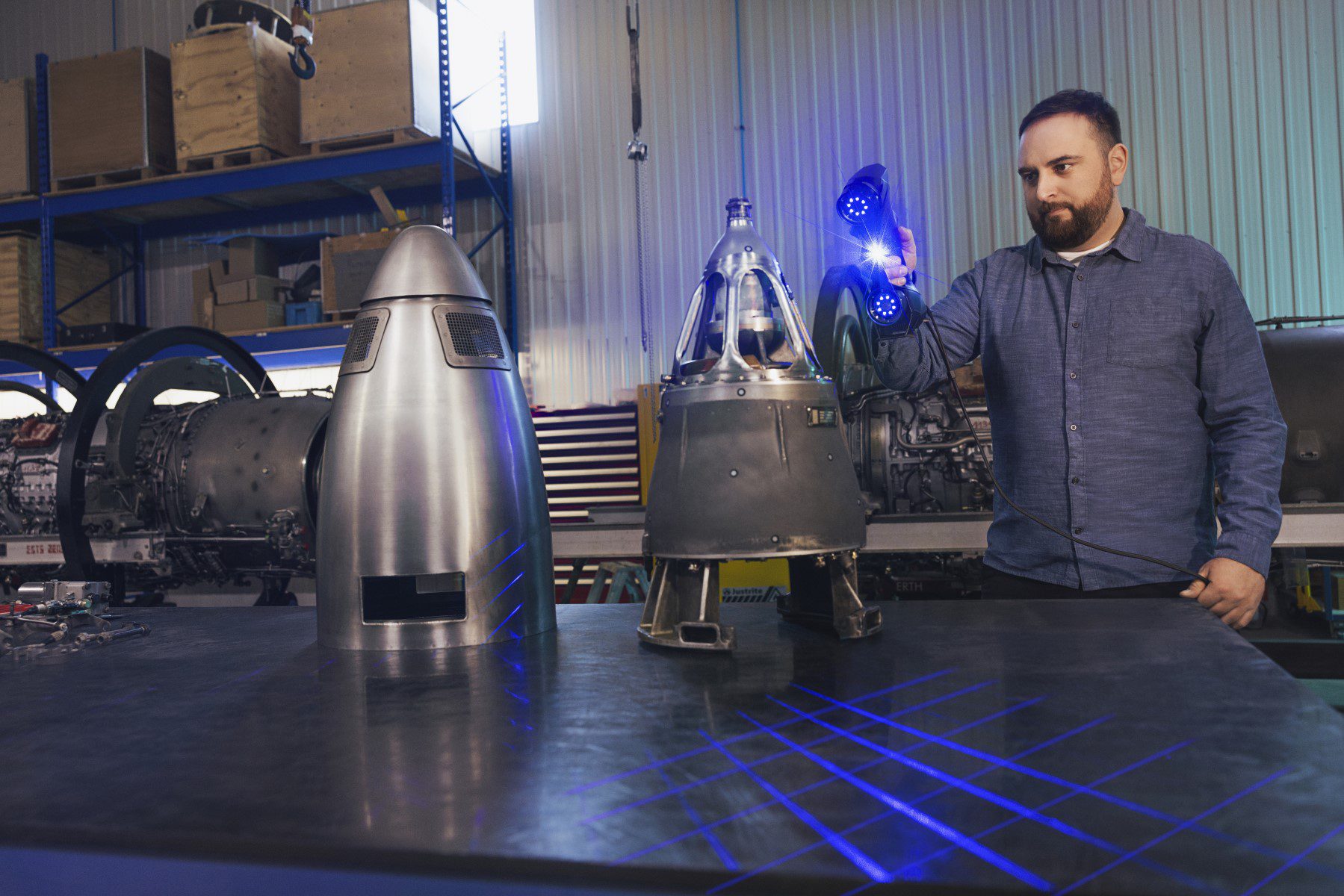 Image shows a technician 3D scanning aircraft engine tail cones with Creaform HandySCAN black Elite 3D scanner