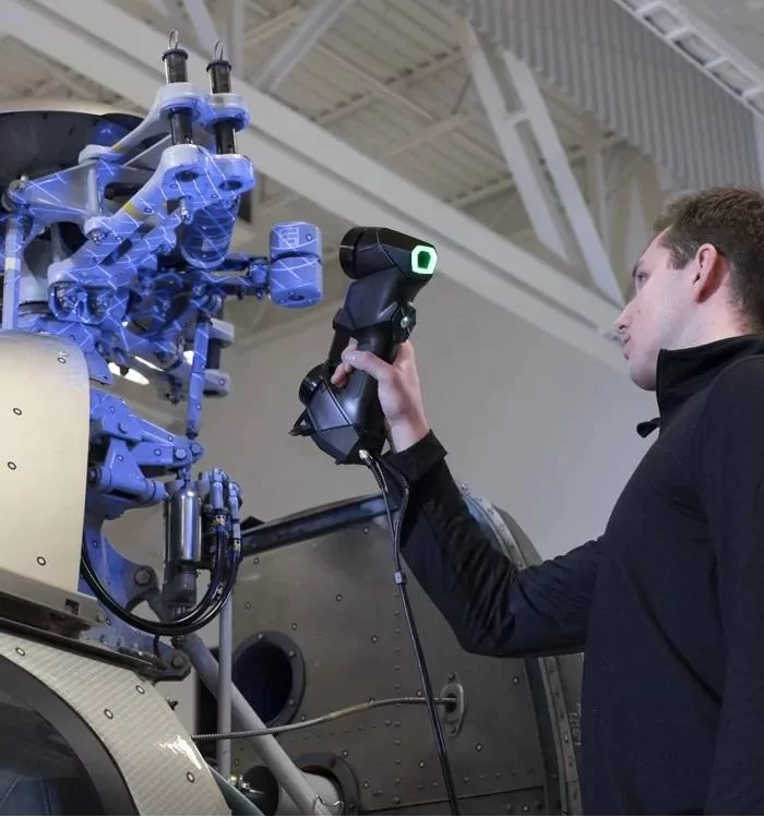 Image shows a technician 3D scanning a large assembly with Creaform HandySCAN Black ELite 3D scanner