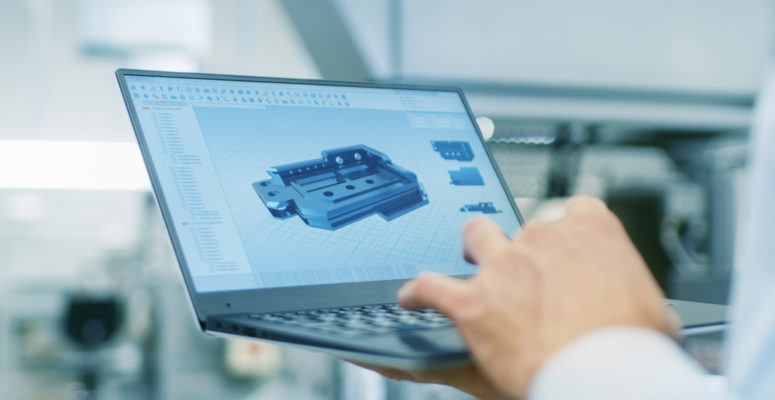 engineer looking at 3d model on laptop