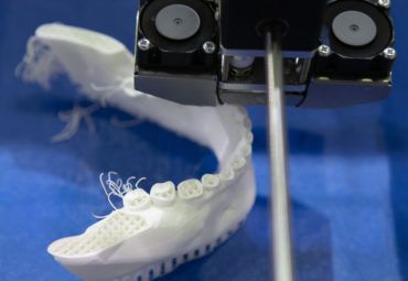 A close-up of 3D dental printing. See how 3D printing lowers costs and improves treatment