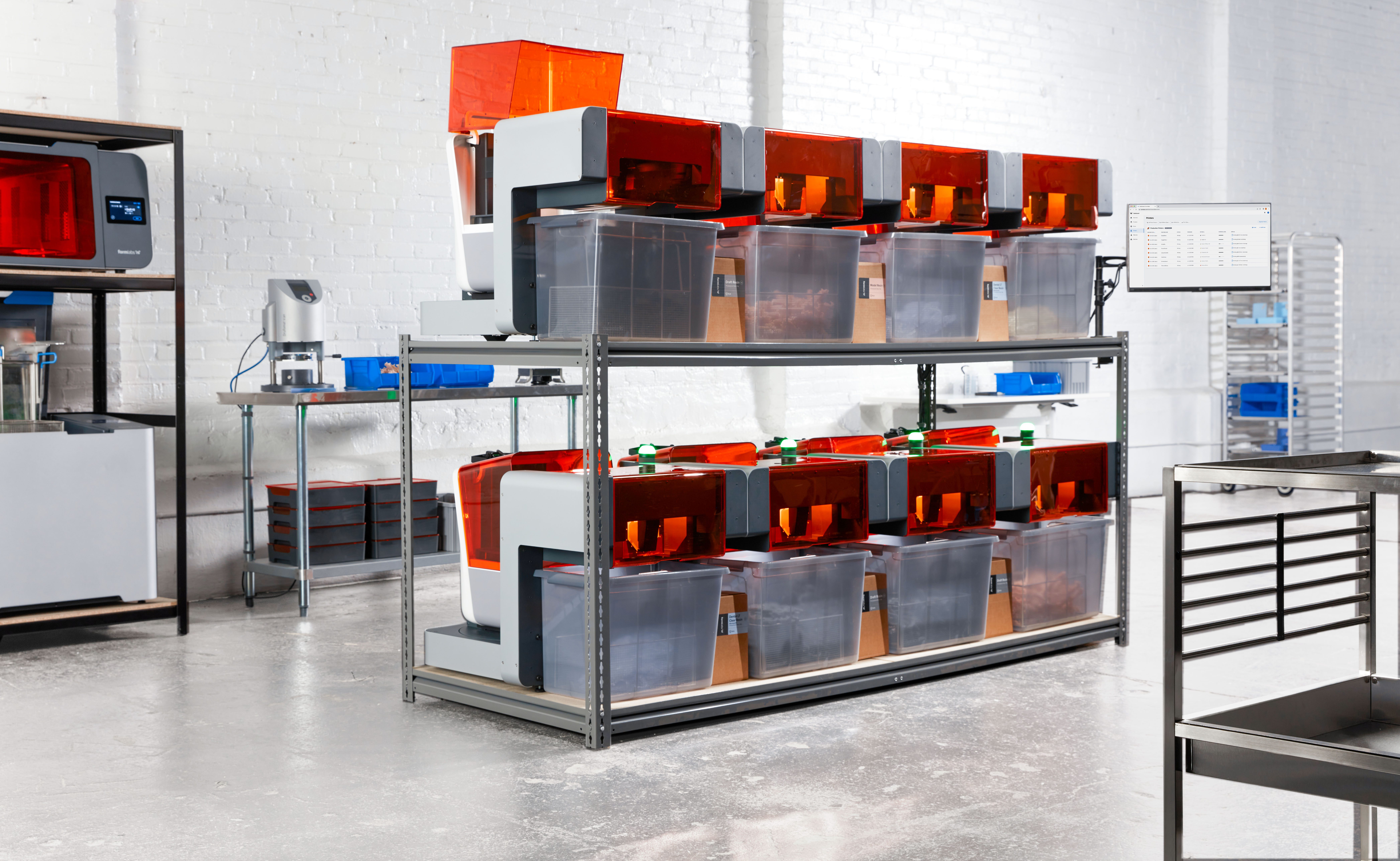 Image shows a lineup of Formlabs SLA 3D printers and Form Auto extensions