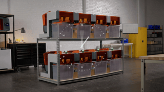 Image shows a fleet of SLA 3D printers form Formlabs