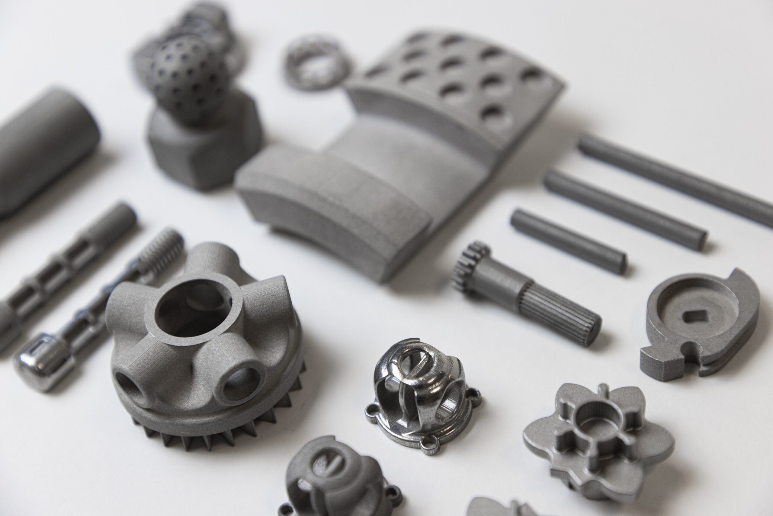 Image shows multiple 3D printed parts by Proto3000